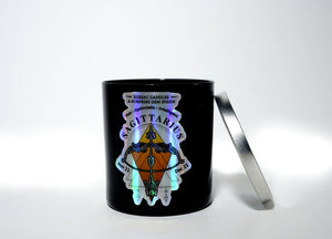 The Zodiac: Sagittarius Candle is a black soy jar with a metallic lid, labeled "Sagittarius" and decorated with zodiac graphics; it also includes a hidden surprise gem inside.