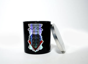 The Zodiac: Leo Candle, a black jar featuring zodiac dates and a lion graphic with a silver lid, brings celestial charm to any space. This all-natural soy candle is perfect for Leo enthusiasts.