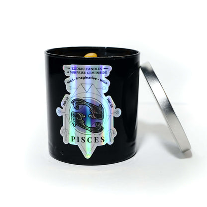 The Zodiac: Pisces Candle features a black gemstone jar with a holographic Pisces label, an open silver lid, and a Lemon Lavender scent, revealing a small object inside.
