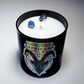 The Zodiac: Capricorn Candle features black wax, white soy interior, two blue crystals on top, and a label with zodiac dates (Dec 22–Jan 19)—an ideal candle for any Capricorn.