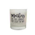 The Mothers Light the Way white glass candle by Custom Candle Co features black script: "Mothers are like candles, they light the way." Made with natural soy, it's a beautiful gift.