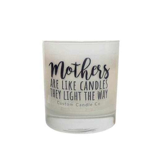 The Mothers Light the Way white glass candle by Custom Candle Co features black script: "Mothers are like candles, they light the way." Made with natural soy, it's a beautiful gift.