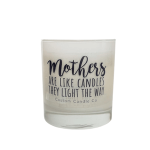 The Mothers Light the Way white glass candle by Custom Candle Co features black script: "Mothers are like candles, they light the way." Made with natural soy, it's a beautiful gift.