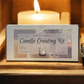 A "Candle Creating Kit" from Custom Candle Co is shown on a wooden tray with a lit candle, featuring premium supplies to craft your own custom candles at home.