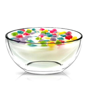 The Cereal Crunchy Berries Candle looks like a clear glass cereal bowl filled with white wax and topped with colorful berry-shaped pieces, mimicking a playful bowl of cereal, all set against a white background.