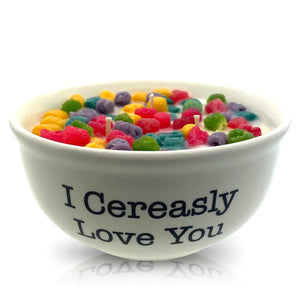 The Cereal Crunchy Berries Cereal Candle with White Quoted Bowl features "I Cereasly Love You," colorful cereal pieces, and three wicks—an eco-friendly, reusable candle that's a fun addition to your home.