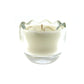 The Clear Glass Easter Egg features a white, egg-shaped candle in a transparent glass holder with a wavy, scalloped rim, displayed against a plain white background.