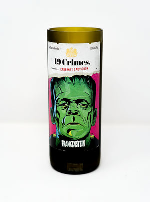 The Recycled Frankenstein Candle is made from a green glass 19 Crimes Cabernet Sauvignon wine bottle with a Frankenstein illustration label, upcycled into a unique recycled bottle candle.