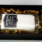 The Recycled American Gin Candle, a natural soy candle in a glass labeled "Aviation American Gin," comes in a black box with brown paper filler beside a small cylindrical container—an eco-friendly accent for any room.