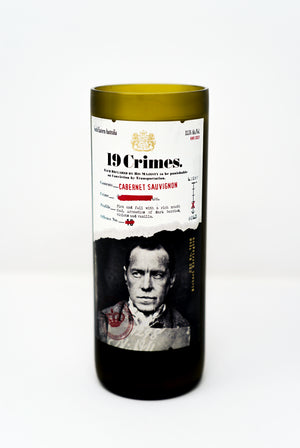 A Recycled Cabernet Sauvignon 2022 Wine Candle featuring a black-and-white portrait label, crafted from an upcycled wine bottle—ideal as a unique, eco-friendly natural candle holder.