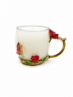 The Enchanted Rose Teacup Candle is a white scented candle in a clear glass mug with gold, red rose, and butterfly accents—an ideal choice for vintage home décor.