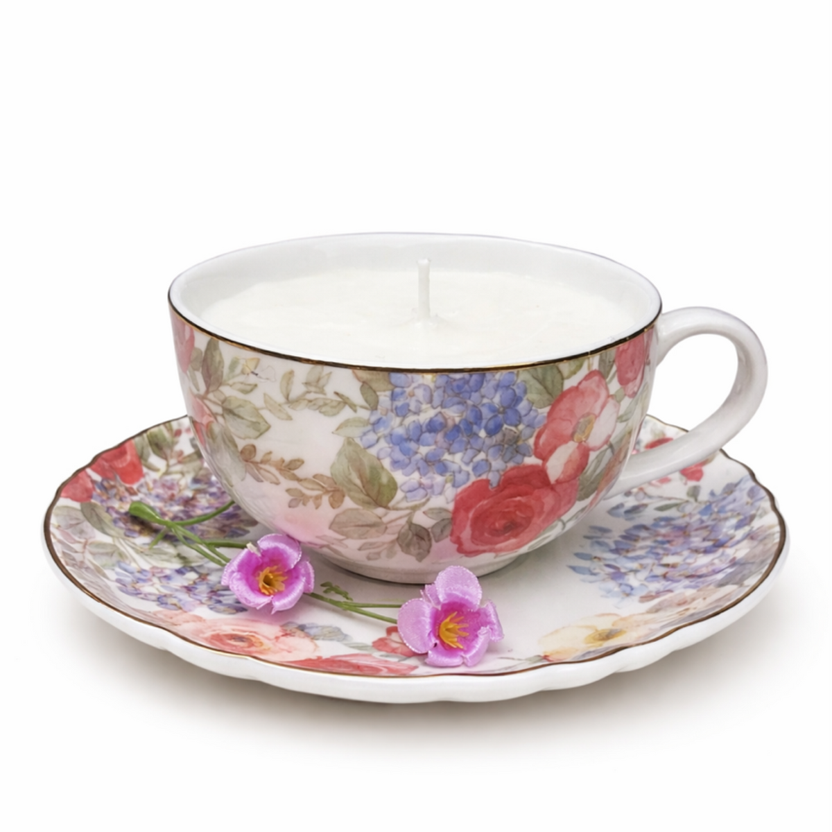 The Large Floral Teacup Candles feature a white soy candle in a floral teacup and saucer, adorned with two small purple flowers on the saucer for a charming touch.