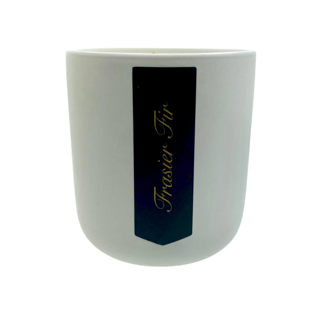 The Holiday Scented Boxed Candle – Frasier Fir Scent features a white soy wax candle with a black label that reads "Frasier Fir" in gold script—ideal for adding festive fragrance to your home.
