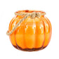 The Glass Pumpkin Lantern is an orange, pumpkin-shaped glass jar with a sturdy twine handle, ideal for festive decor. Displayed against a white background.