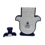A Recycled Blanco Tequila Candle made from a white and blue Casa de Hamsa Tequila Blanco bottle shaped like a Hamsa hand, shown with its matching cap—perfect for upcycling into a unique candle.
