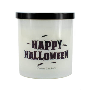 The Happy Halloween Candle features a white frosted jar, black lid, bold “Happy Halloween” text, and bat graphics. Made by Custom Candle Co. from soy wax, it’s perfect for creating a festive mood.