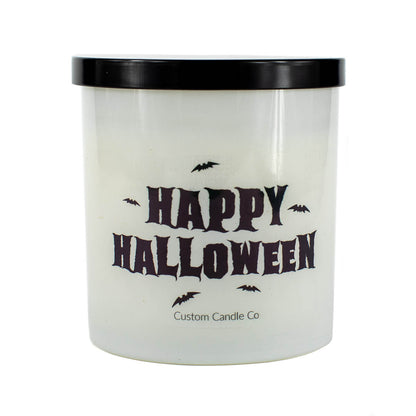 The Happy Halloween Candle features a white frosted jar, black lid, bold “Happy Halloween” text, and bat graphics. Made by Custom Candle Co. from soy wax, it’s perfect for creating a festive mood.