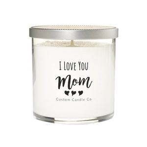 The "I Love You Mom" White Glass Candle features white soy wax in a clear jar with a silver lid. The label displays three hearts and "Custom Candle Co"—a perfect custom gift to express your love to mom.