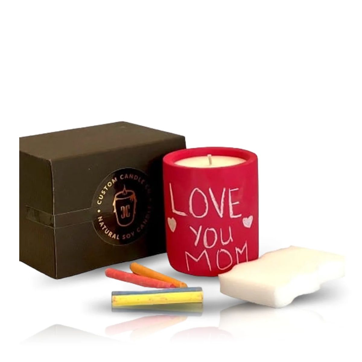 The Intention Red Candle, featuring "Love You Mom," is shown with a black gift box, three colored chalks, and a white eraser on a white background.