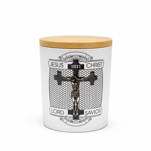 White container candle with wooden lid featuring a crucifixion design and text on a white background