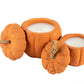 Three pumpkin-shaped candles, featuring the Orange Cement Pumpkin Candle with a rope handle, are arranged against a white background; each one displays a unique wick and charming fall-themed detail.
