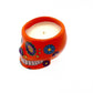 Large Orange Ceramic Skull Candle with vibrant floral patterns, featuring a white nutmeg-scented soy wax candle.