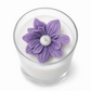 Candle with a purple flower-shaped candle top on a white background