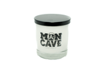 A white natural soy candle in a clear glass jar with black lid. The label reads "Man Cave"—perfect for any man cave or as a unique gift for dad.