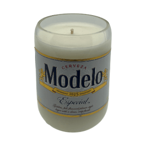 The Recycled Especial Beer Candle is a white, hand-poured candle in a glass made from a recycled Modelo Especial bottle with its original label—an eco-friendly, sustainable choice.