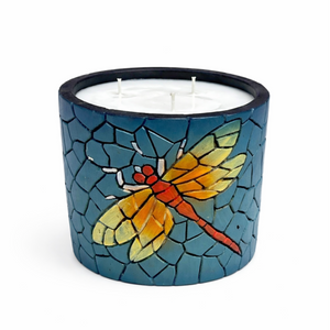 Candle in a mosaic holder with a dragonfly design on a white background