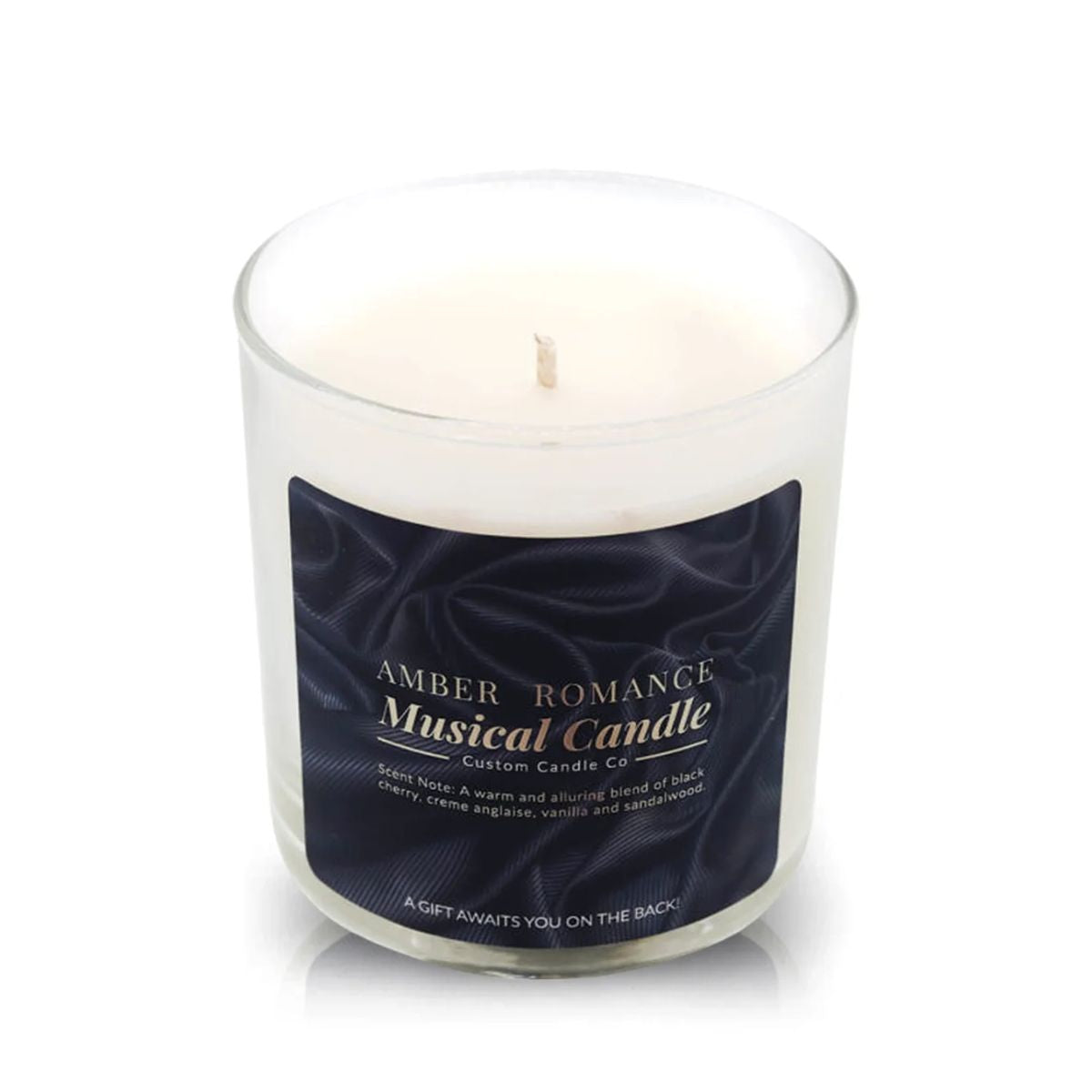The Musical Love Candle – Amber Romance, a white scented candle in a clear glass jar with scent notes and product details, is the perfect touch for any Valentine’s Day setting against a dark background.