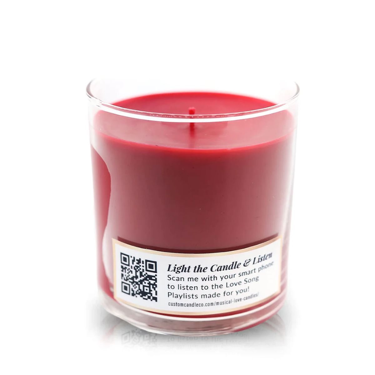 The Musical Love Candle – Fresh Cut Roses is a red scented candle in a clear glass jar, featuring a label with a QR code and text to scan and enjoy custom playlists—ideal for Valentine’s Day or anyone who loves music-inspired candles.