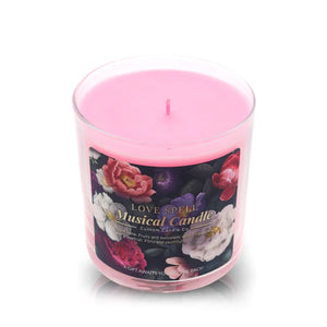 The Musical Love Candle – Love Spell is a pink scented candle in a clear glass container with a floral label, featuring vibrant flower images. Ideal for Valentine’s Day and those who love unique musical candles.