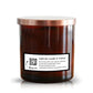 The Musical Spa The Spa Candle is a brown soy candle jar with a copper lid and a label featuring a QR code to scan for a music playlist, enhancing your candle lighting experience.