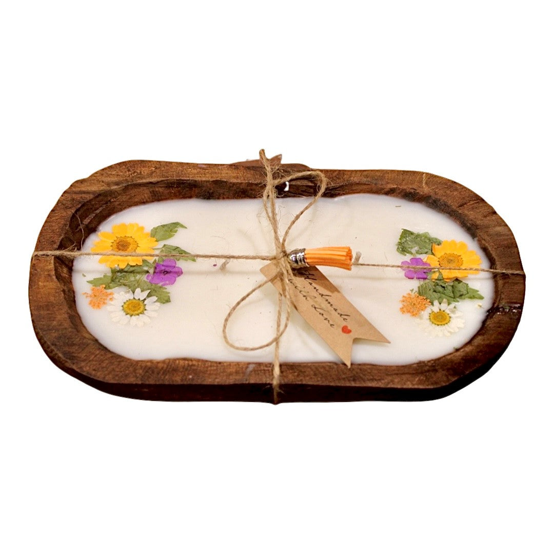 The Orange Floral Wood Candle—Floral Scented—is a natural soy wax candle with pressed flowers, displayed in an oval wooden tray. Finished with twine and a tag, it creates a charming rustic centerpiece.