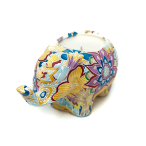 Nima the Ceramic Elephant Candle features colorful floral and geometric patterns and holds an all-natural soy candle to brighten your space.