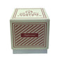 A square box labeled "Holiday Scented Boxed Candle – Peppermint Scent" holds a peppermint-scented candle, featuring red and white diagonal stripes on the front.