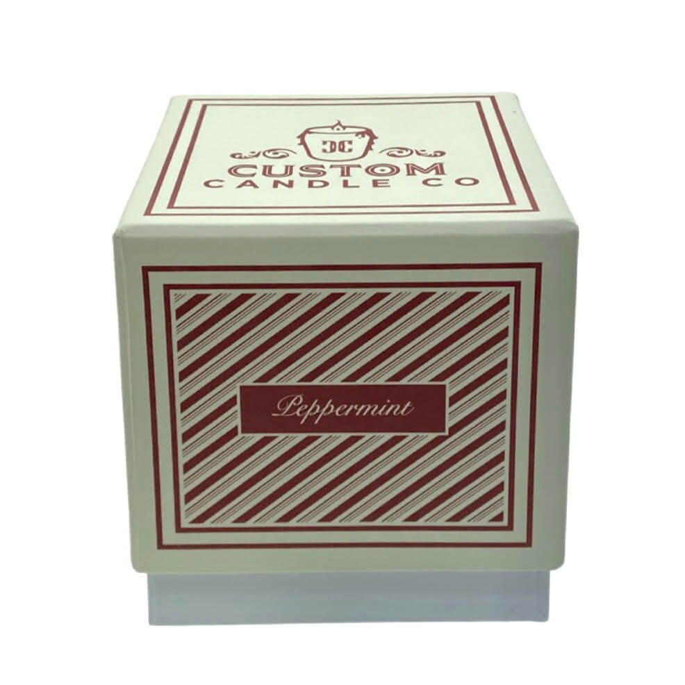 A square box labeled "Holiday Scented Boxed Candle – Peppermint Scent" holds a peppermint-scented candle, featuring red and white diagonal stripes on the front.