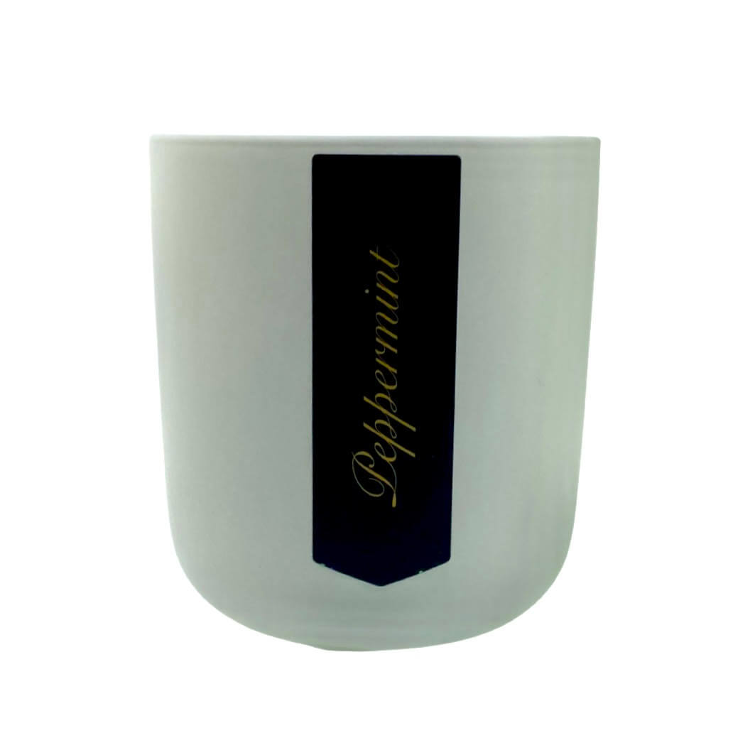 The Holiday Scented Boxed Candle – Peppermint Scent comes in a white cylindrical container with a black label featuring "Peppermint" in gold cursive, and is made with natural soy wax for a fresh peppermint fragrance.