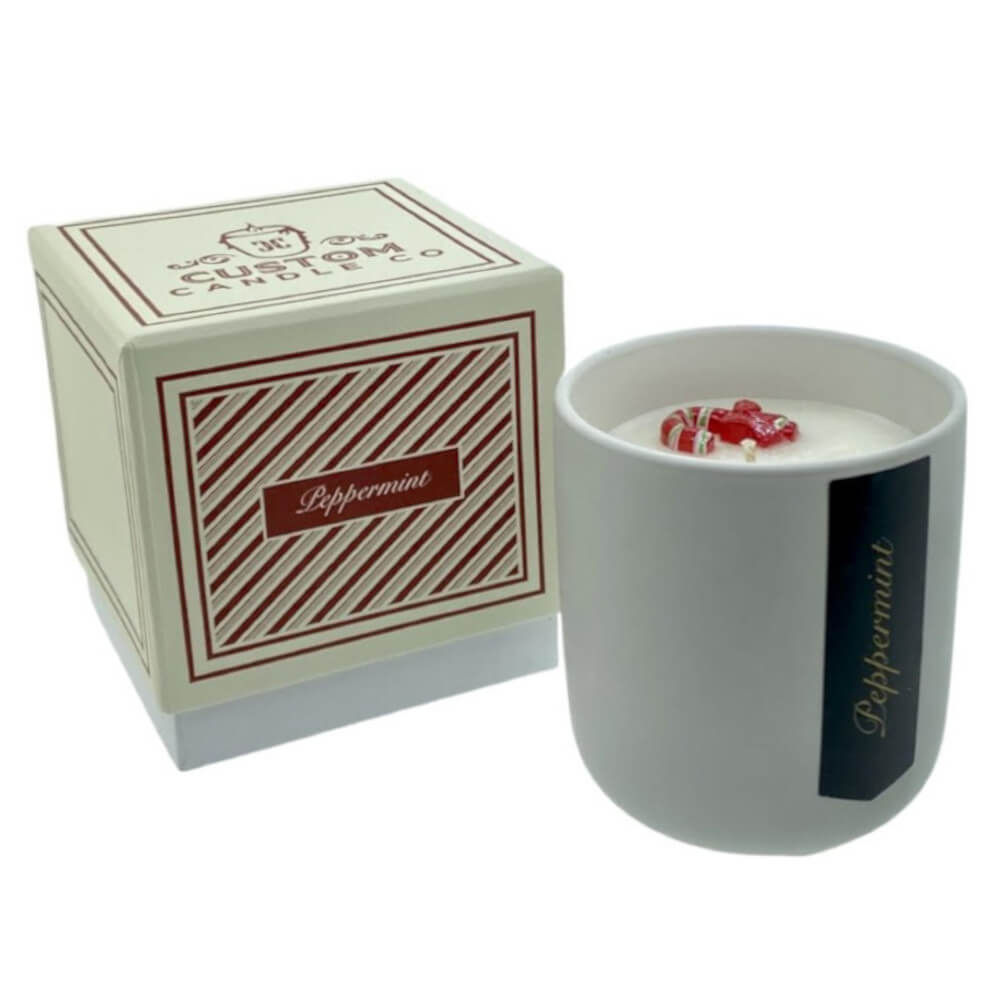 The Holiday Scented Boxed Candle – Peppermint Scent comes in a white jar with a matching red and white striped box. Made from natural soy wax, it brings a refreshing peppermint fragrance to your home.
