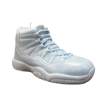 The AJ-11 Baby Blue Hightop Sneaker Candle – Large (On Backorder) is a hand-poured candle crafted to resemble a classic athletic shoe, shown on a white background.