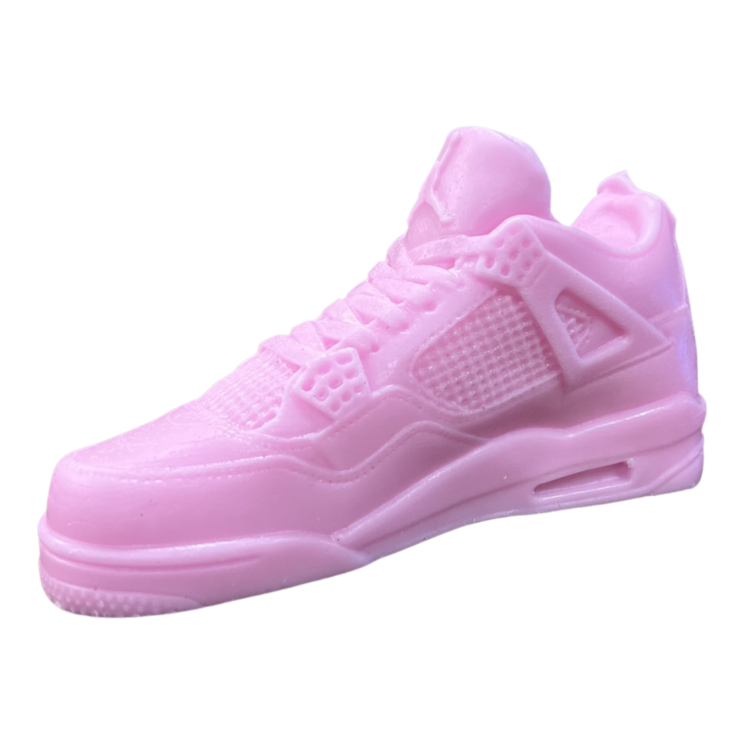 The AJ-4 Baby Pink Sneaker Candle – XL (On Backorder) is a hand-poured candle with detailed textures, crafted to resemble an athletic shoe and shown against a white background.