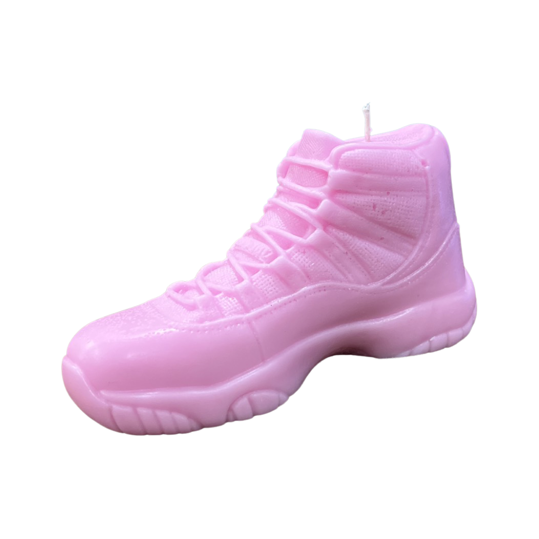 The AJ-11 Baby Pink Hightop Sneaker Candle – Large (On Backorder) features a black ice fragrance and is shaped like a high-top sneaker, shown against a white background.