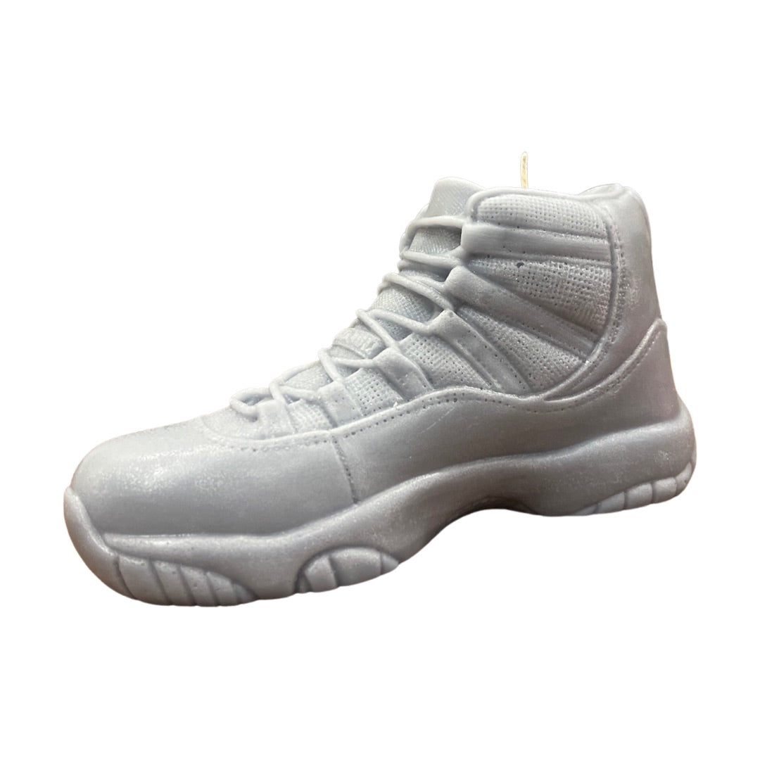 The AJ-11 Gray Hightop Sneaker Candle – Large (On Backorder) is a hand-poured candle shaped like a high-top athletic shoe, displayed against a white background and scented with the fresh aroma of Black Ice fragrance.