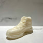 The AJ-11 White Hightop Sneaker Candle – Large (On Backorder) is shown on a light surface against a marble-patterned background.