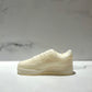 The AF1 – White Lowtop Sneaker Candle – Large (On Backorder) is a white sneaker-shaped candle inspired by athletic shoes, displayed on light marble and featuring the refreshing scent of Black Ice fragrance.