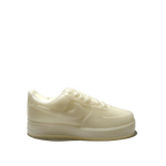The AF1 – White Lowtop Sneaker Candle – Large (On Backorder), a cream-colored translucent candle shaped like a white lowtop sneaker, is shown against a plain light gray background.