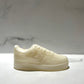 The AF1 – White Lowtop Sneaker Candle – Large (On Backorder) is designed to look like a real sneaker and is displayed on a marble surface with a plain background.
