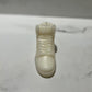 The AJ-1 White Hightop Sneaker Candle – Large (currently on backorder) is a glossy, hand-poured white candle shaped like a sneaker, set on a white marble surface and subtly scented with Black Ice fragrance.