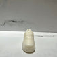 The AF1 – White Lowtop Sneaker Candle – Small (On Backorder), hand poured with Black Ice fragrance, rests on a white marble surface against a light gray marble background.